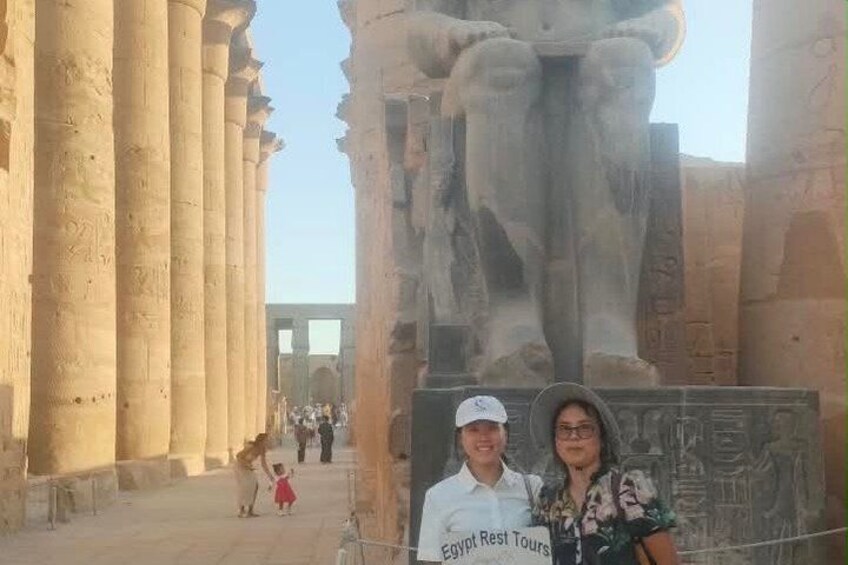 Ancient Egyptian columns, a large statue, and a sign for Egypt Rest Tours. 3