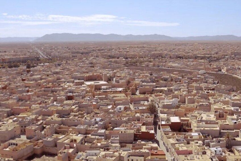 A sprawling urban landscape with dense housing and a prominent river or canal running through the center. 3