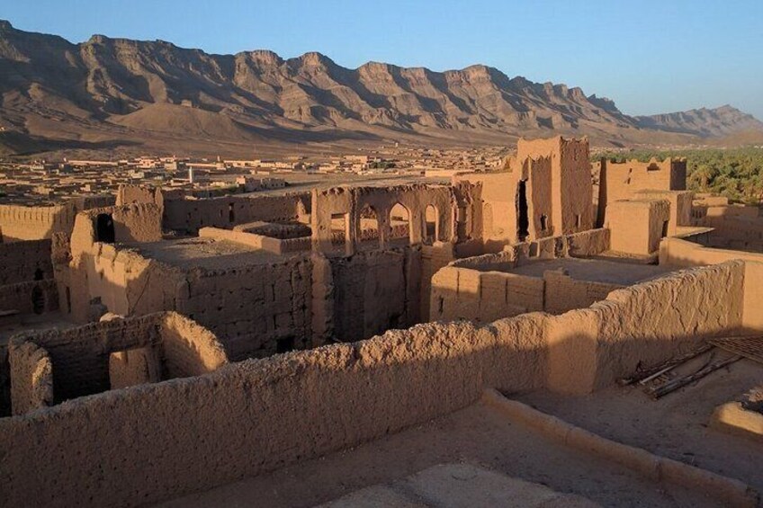 Ancient ruins with mountains in the background. 2