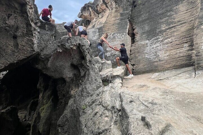 People climbing a rocky cliff. 4