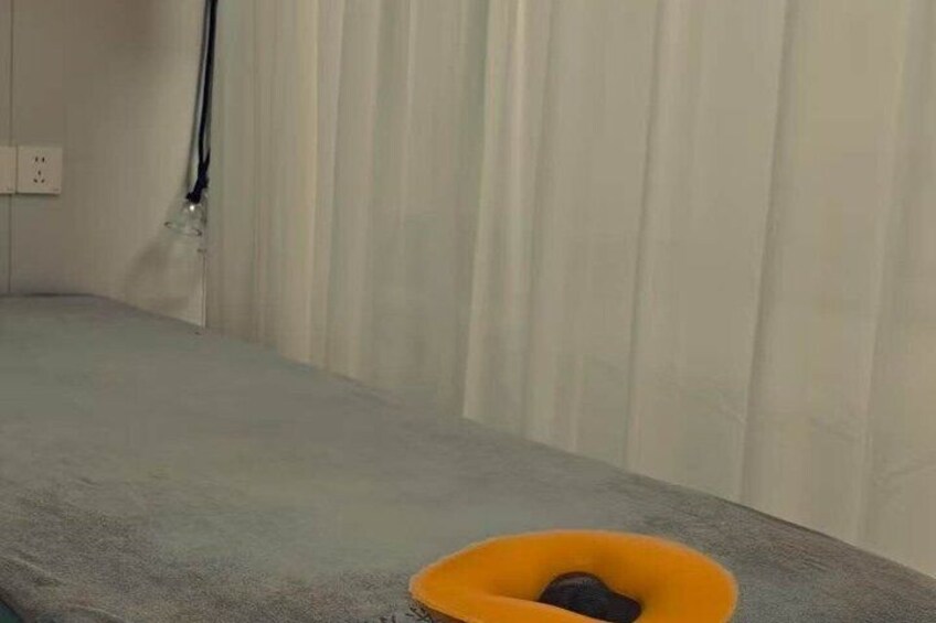 A room with a grey carpet, a yellow object on the floor, and a white wall with a power outlet. 3