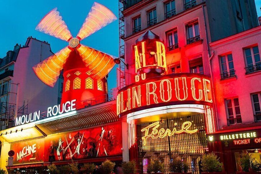 A brightly lit building with signs for Moulin Rouge and Alhambra. 3