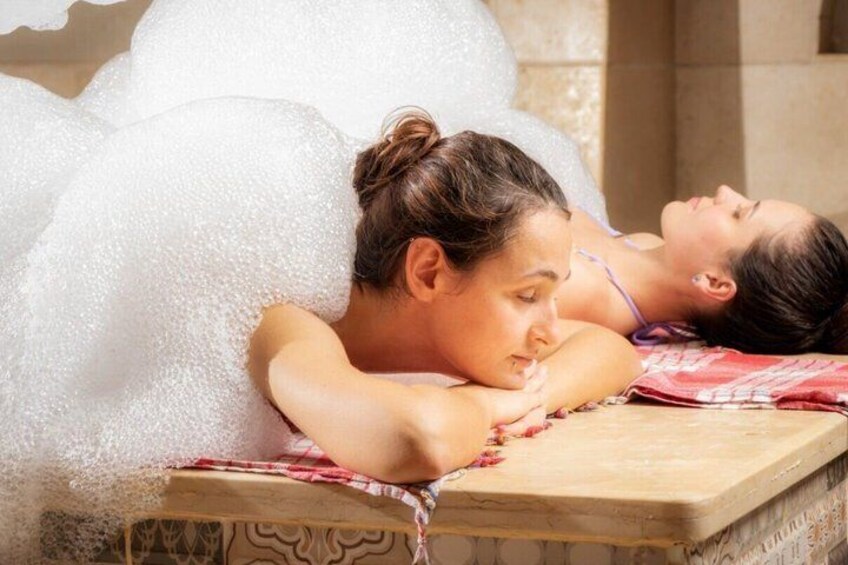 Two people relaxing in a spa bath with bubbles. 3