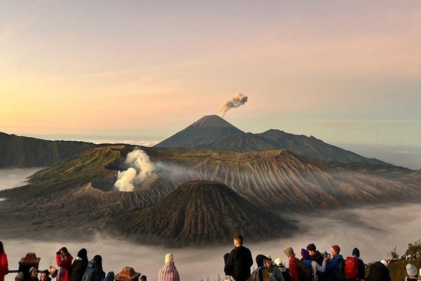 A volcanic landscape with a crowd observing the activity. 1