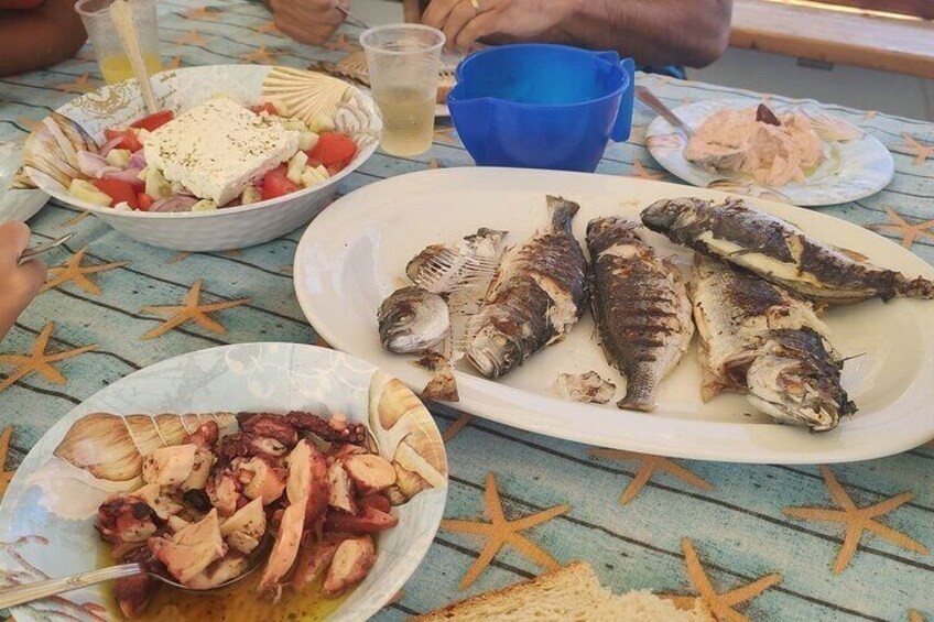 A table with seafood dishes, starfish, and a blue cup. 5