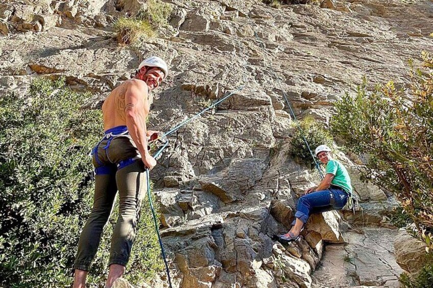 Two people engaged in outdoor climbing activities on rocky terrain. 4