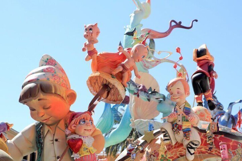 A colorful sculpture with various characters and animals. 3