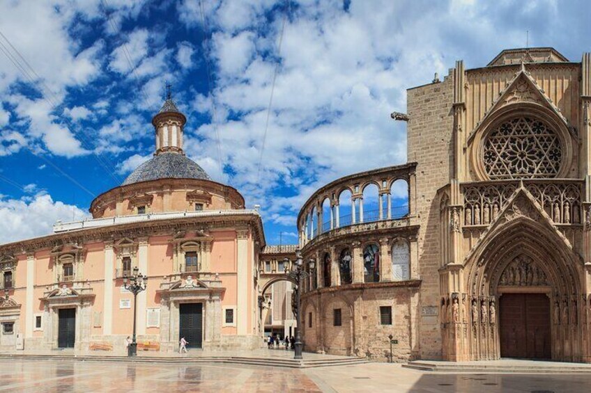 A historic building with a dome and a Gothic-style entrance. 2