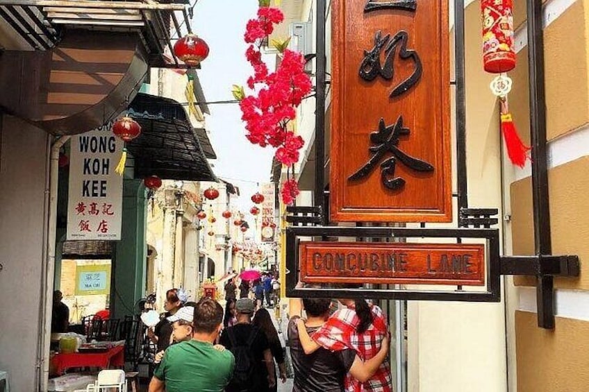 A bustling street with traditional architecture, red lanterns, and signs in a foreign language. 5