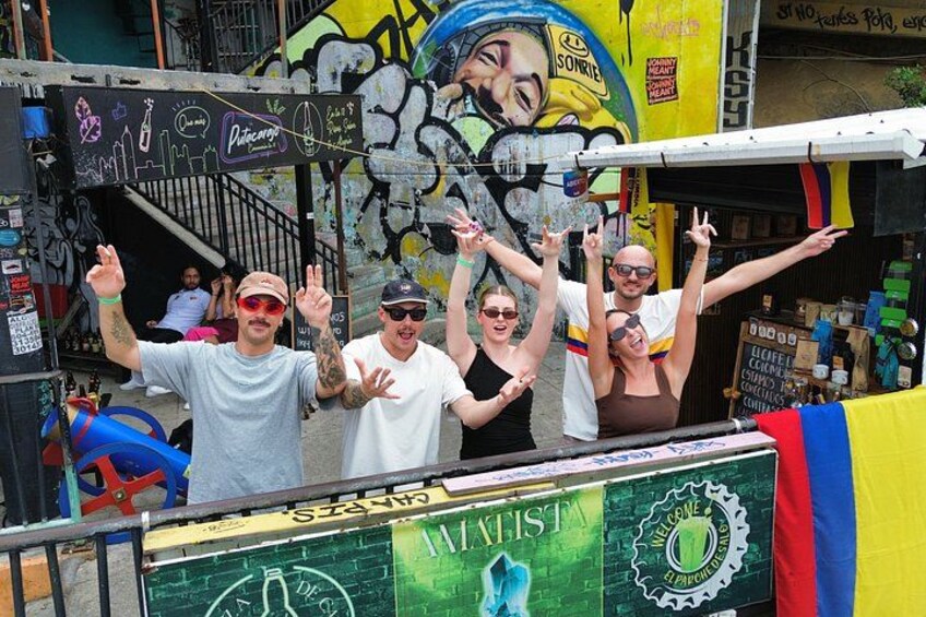 A group of people on a street with graffiti and a sign that says 'WATIST'. 2