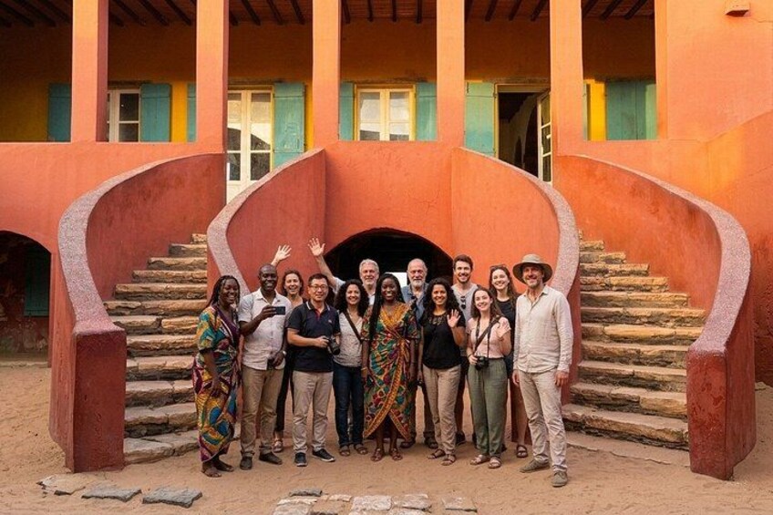 A group of people standing in front of a building with a spiral staircase. 4