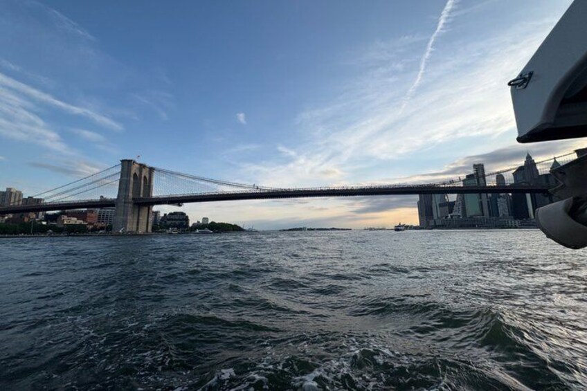 A bridge over water with a city skyline in the background. 3