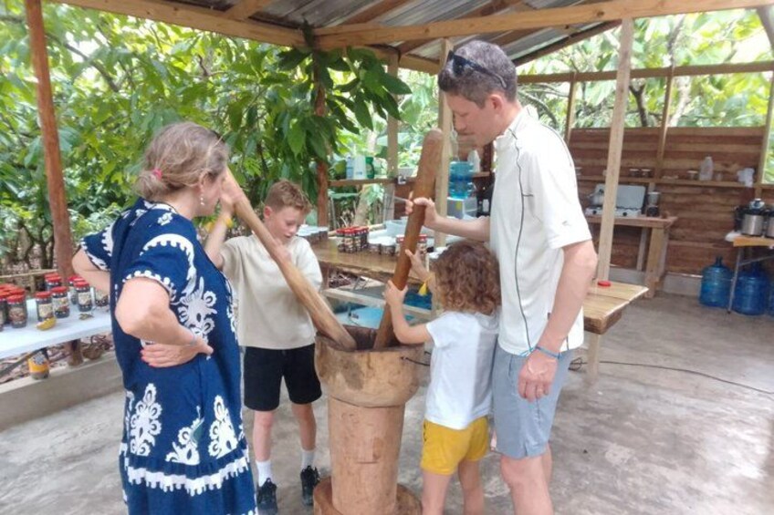 A group of people around a large wooden barrel, possibly engaged in a traditional activity. 1