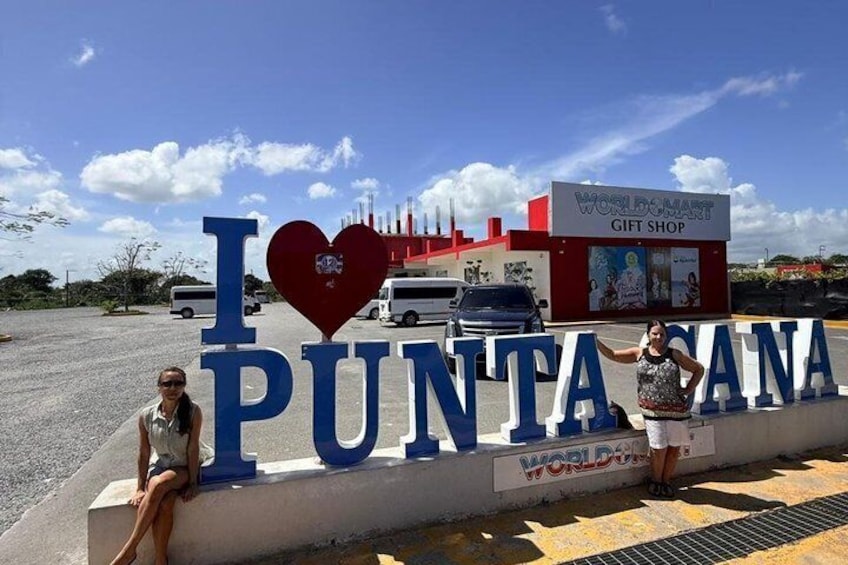 A large sign with 'I ♥ PUNTA SANA' and a WorldMart gift shop in the background. 4