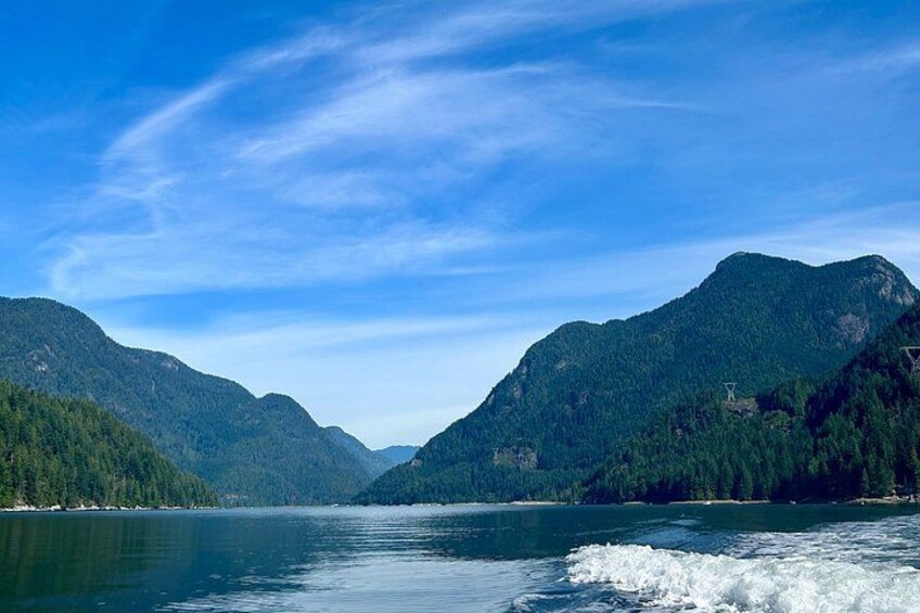 A lake surrounded by mountains under a clear sky. 4