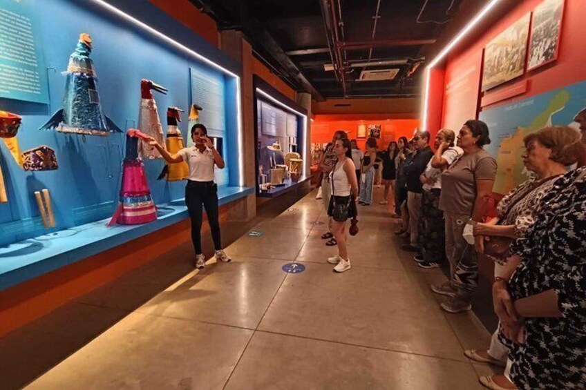 A museum corridor with exhibits and visitors. 2