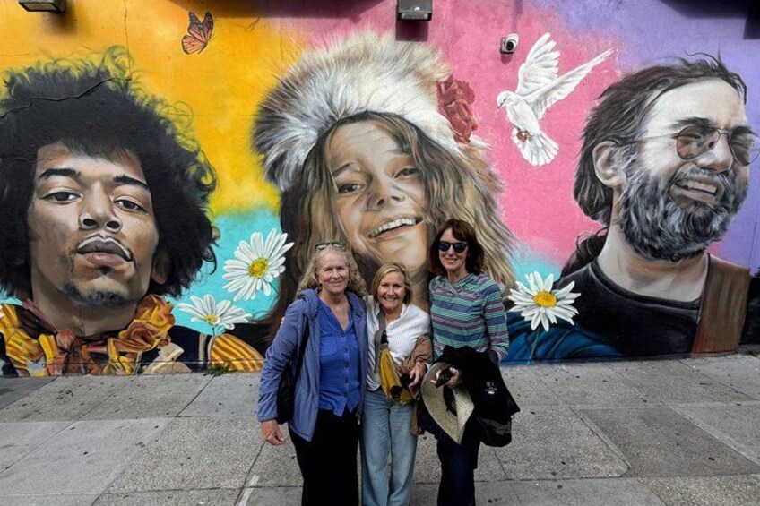 A mural with portraits and doves on a wall. 2