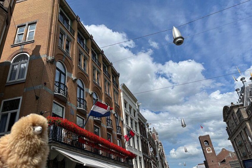 A street with buildings, a flag, and a clear sky. 2