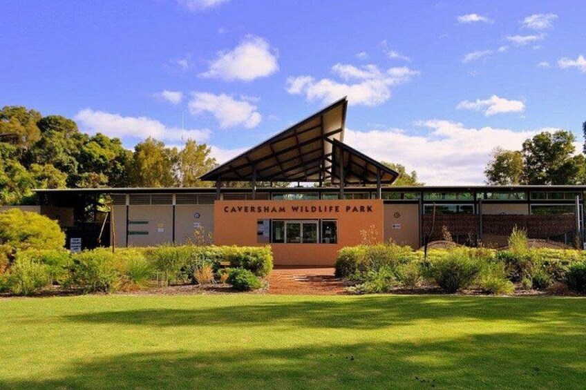 A building labeled 'Caversham Wildlife Park' with a covered entrance and surrounding greenery. 1