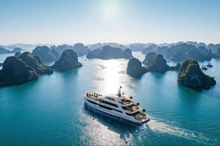 A cruise ship navigating through a series of limestone islands in a turquoise sea. 3