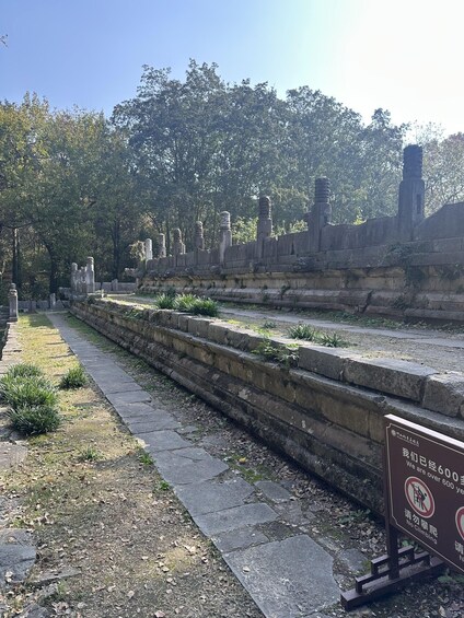 Ancient stone structures, a stone pathway, and a sign indicating the site is over 600 years old. 3