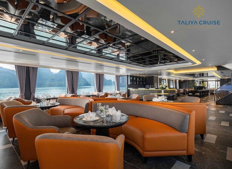 A modern interior with orange seating and a bar area. 5