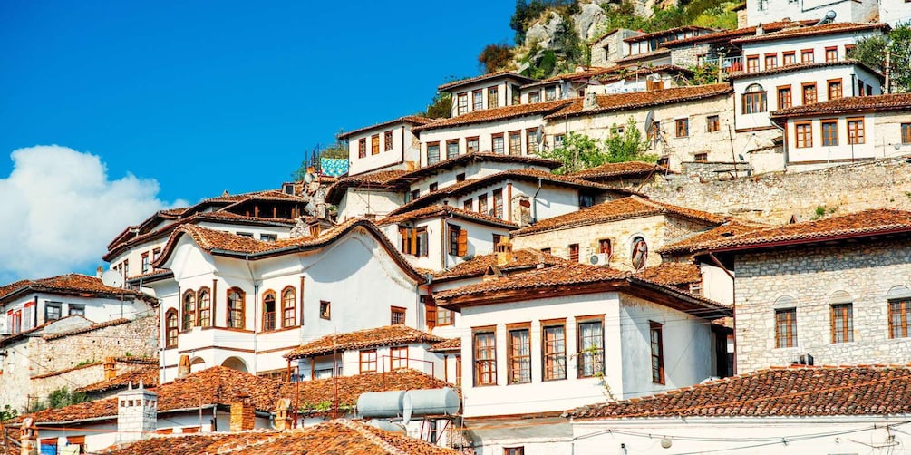 A hillside village with terracotta-tiled roofs and white-washed buildings. 3