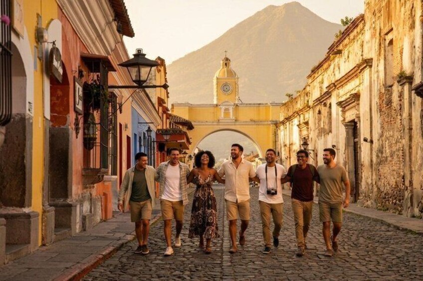 A cobblestone street with historic buildings, a clock tower, and a mountain in the background. 5