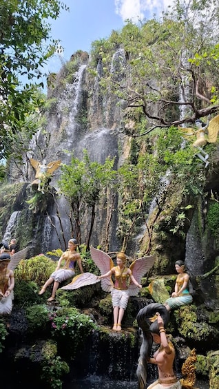 A waterfall with statues of winged figures. 4