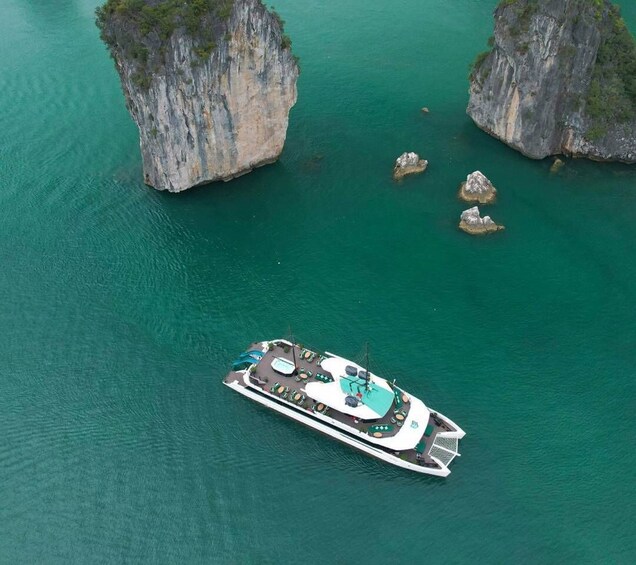 A boat anchored near rocky cliffs in turquoise waters. 5