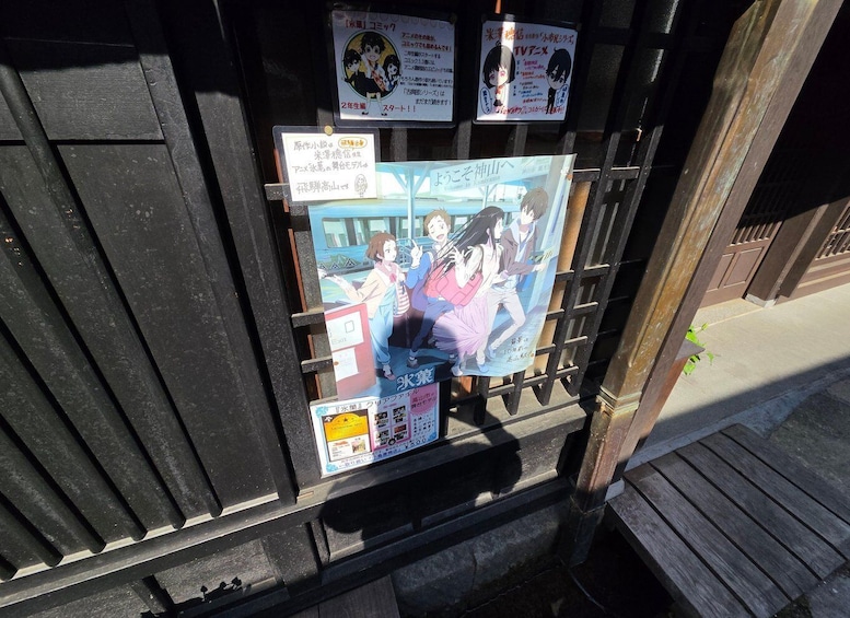 A wooden structure with anime posters and signs. 5