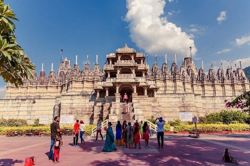 A large, ornate temple with multiple spires and a central entrance. People are gathered around the temple, some taking photos. 5