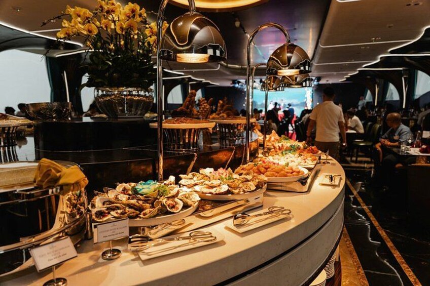 A buffet with various food items and a person walking in the background. 2