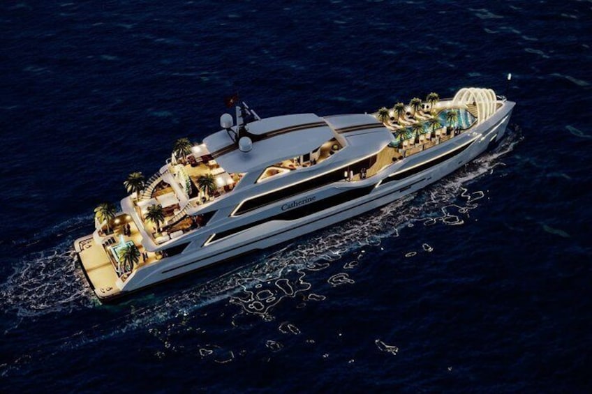 A large, luxurious yacht with multiple decks, palm trees, and outdoor seating areas. 1