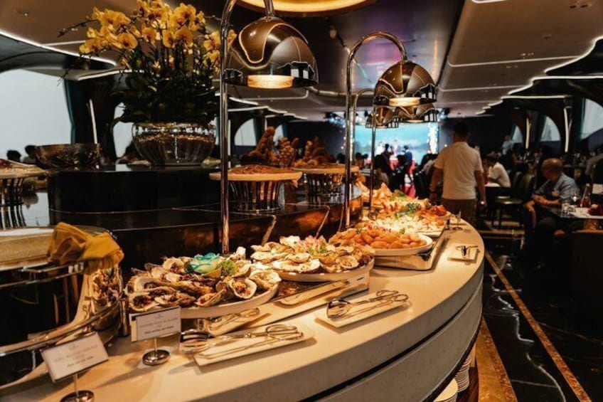 A buffet with various food items and a person walking in the background. 2