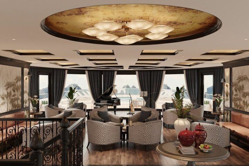 A luxurious interior with a piano, patterned sofas, and a view of the sea. 3