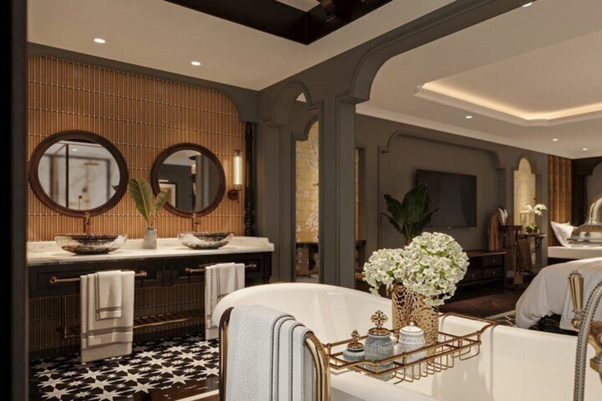 A modern bathroom with a bathtub, two sinks, and a large mirror. 2