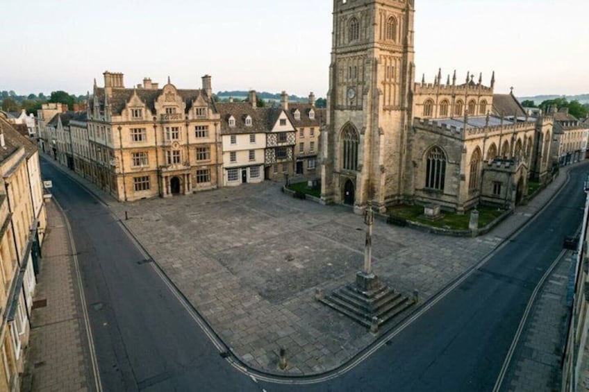 A historic square with a prominent clock tower, surrounded by traditional buildings. 5