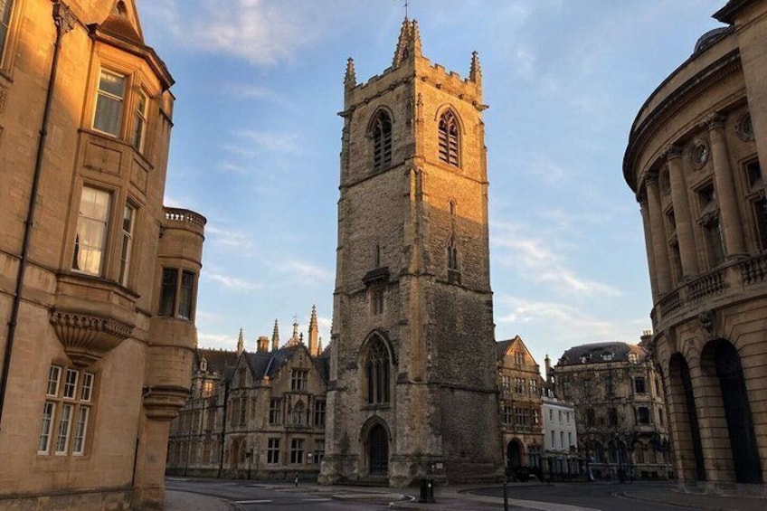A historic tower with a clock, surrounded by classical architecture. 1