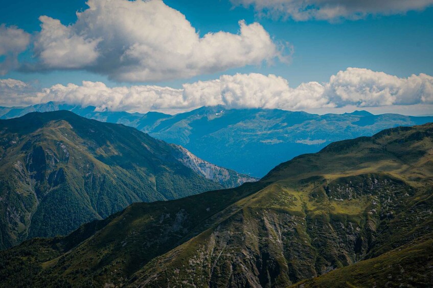 A mountainous landscape with a clear sky and distant peaks. 3