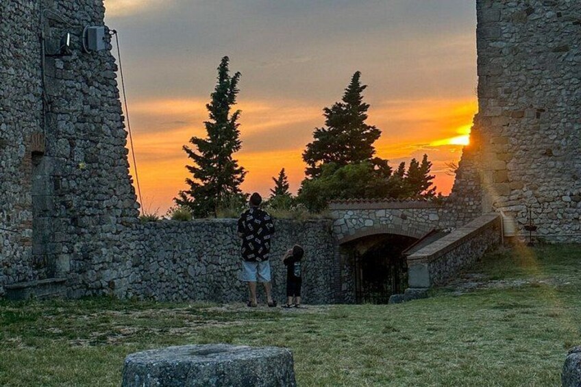 A stone structure with a sunset in the background. 4