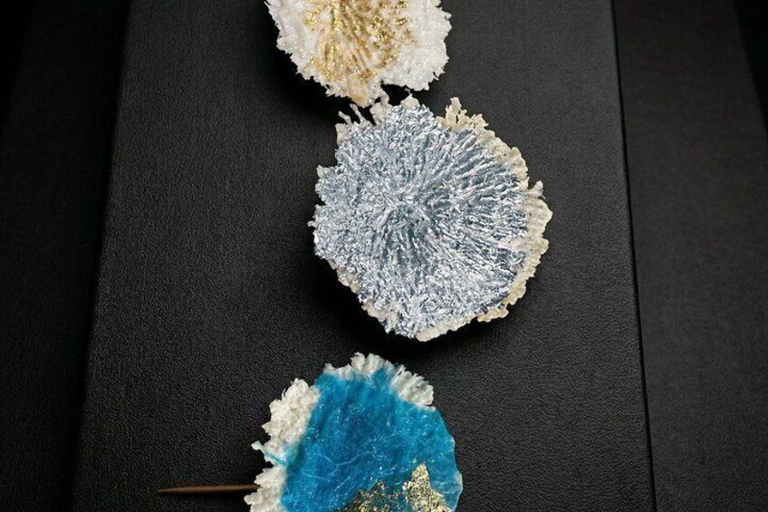 Three textured objects on a black surface. 5