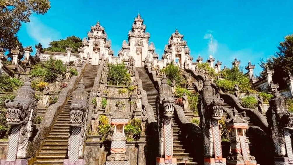 A temple complex with multiple staircases leading to ornate structures. 2
