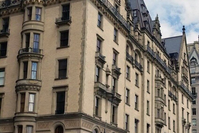 A multi-story building with ornate architectural details, including a corner turret and decorative moldings. 3
