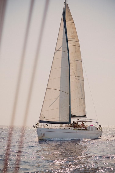 A sailboat with a large sail on the water. 5