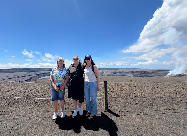 Three people standing on a rocky terrain with a vast landscape in the background. 5