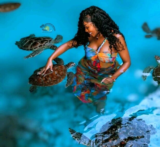 A person in a colorful dress with sea turtles swimming around. 1
