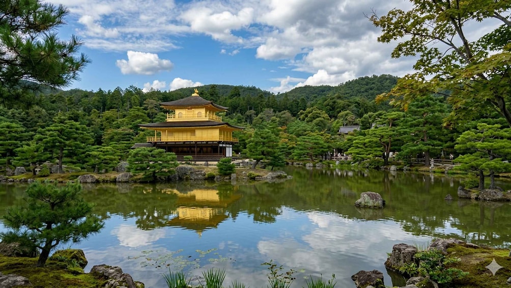 A traditional Japanese temple with a golden roof, surrounded by a serene pond and lush greenery. 2