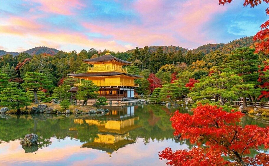 A traditional Japanese building surrounded by a serene pond and autumn foliage. 4