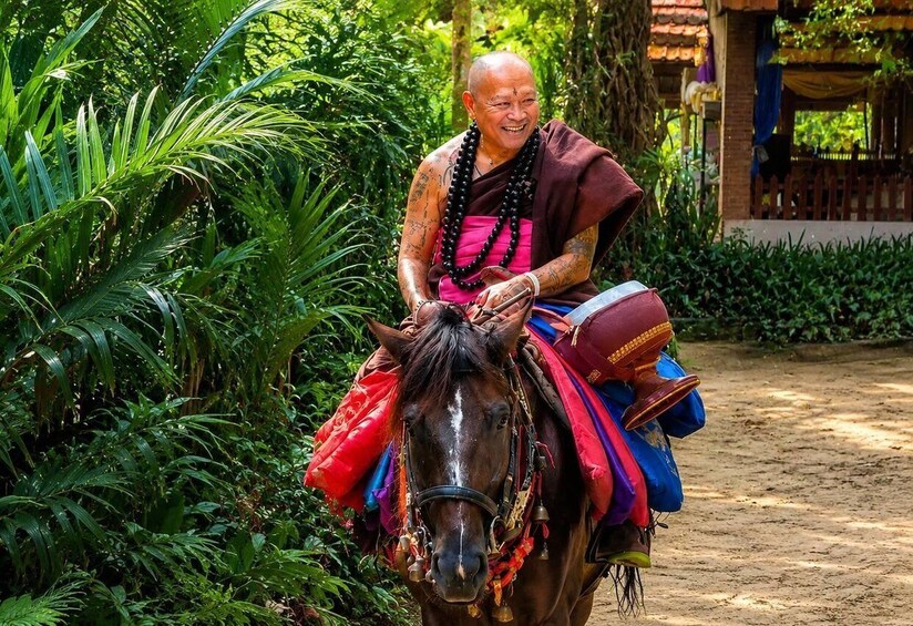 A person riding a decorated horse through a lush garden. 5